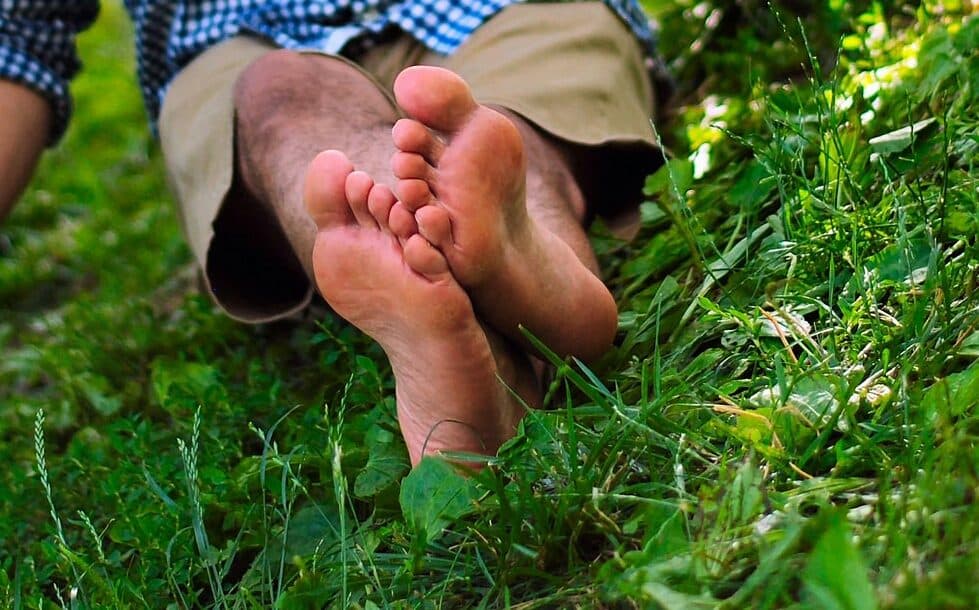 Bare feet resting on grass